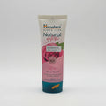 Himalaya Natural Glow Rose Face Wash tube on a shelf with a blurred store background