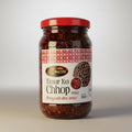 Jar of Timur Ko Chhop pickle with a red lid on a light background